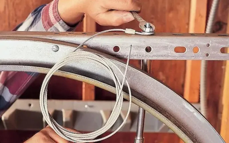 Garage door tune-up process showing inspection lubrication and maintenance in Durham NC